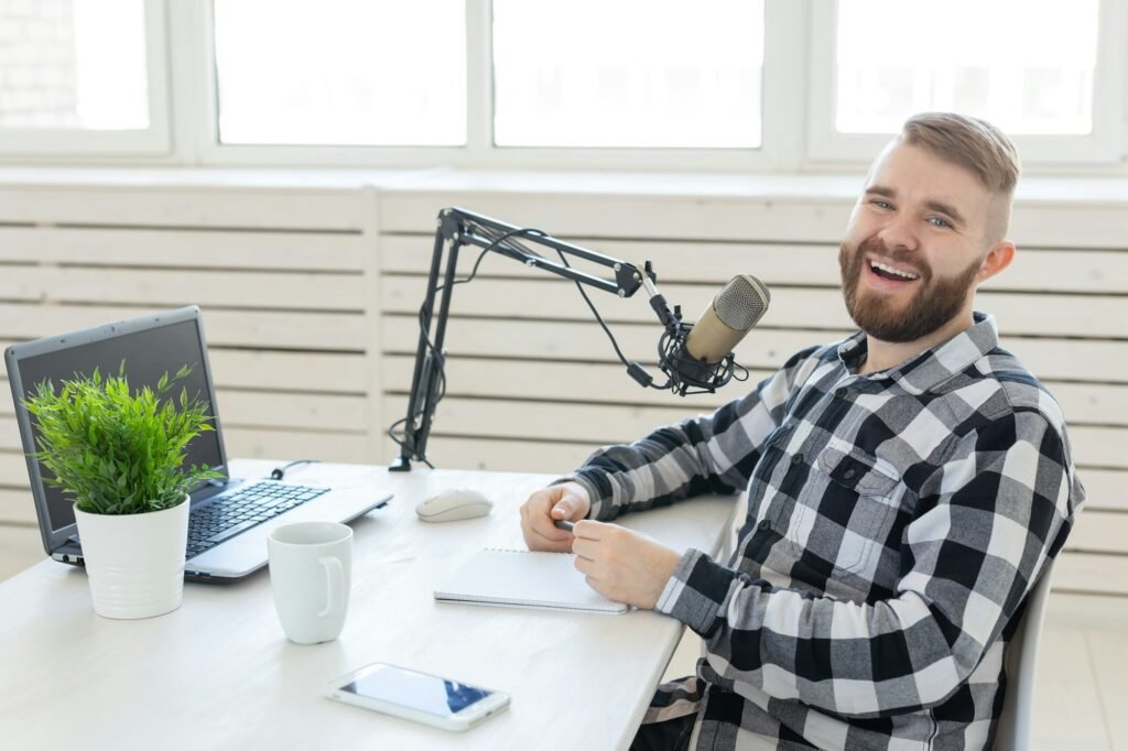 Radio, DJ, blogging and people concept - man working as a DJ on the radio