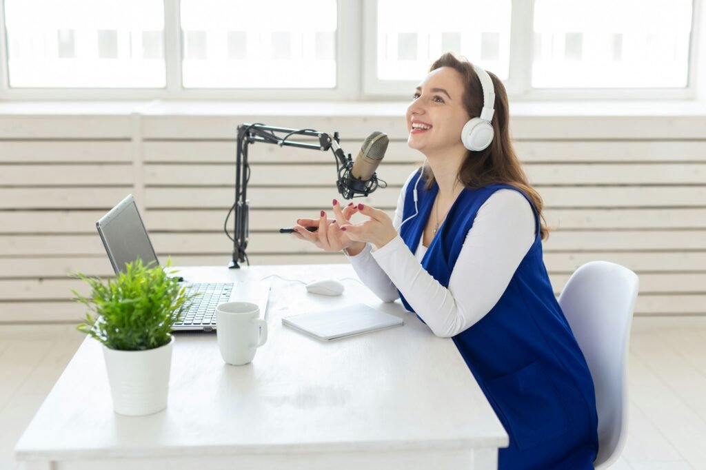 Radio host concept - Woman working as radio host sitting in front of microphone over white